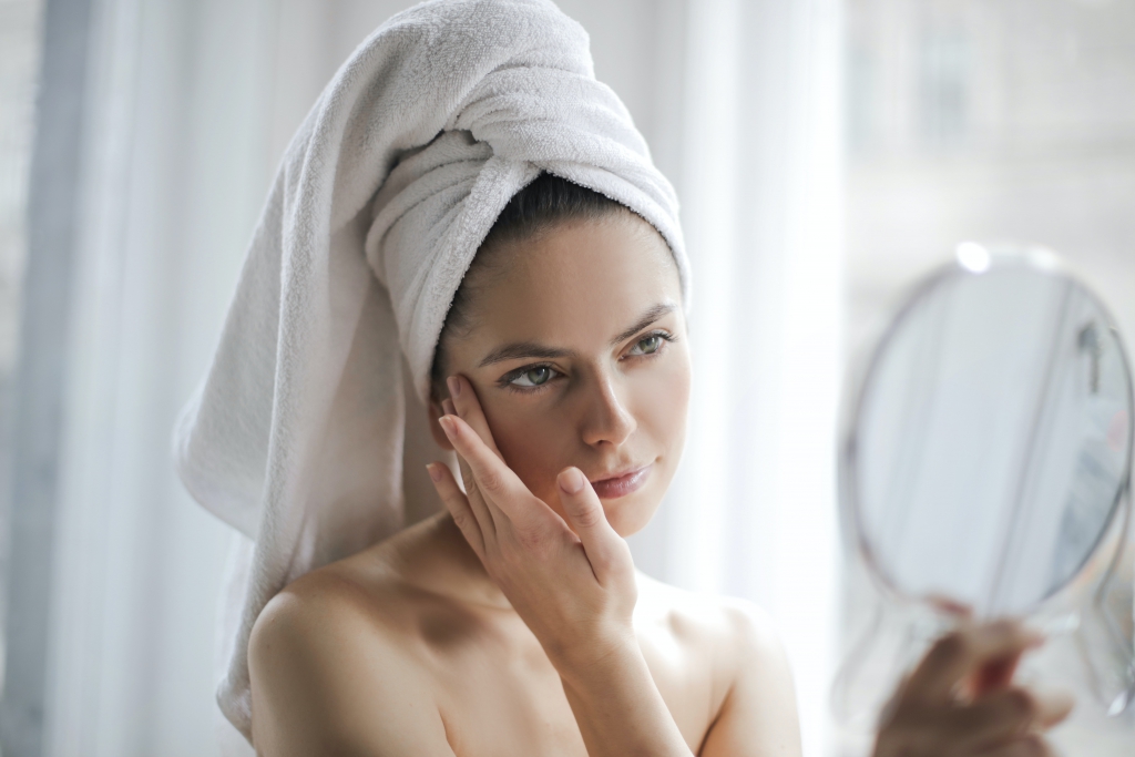 tender-woman-after-shower-examining-skin-with-mirror-3754678.jpg